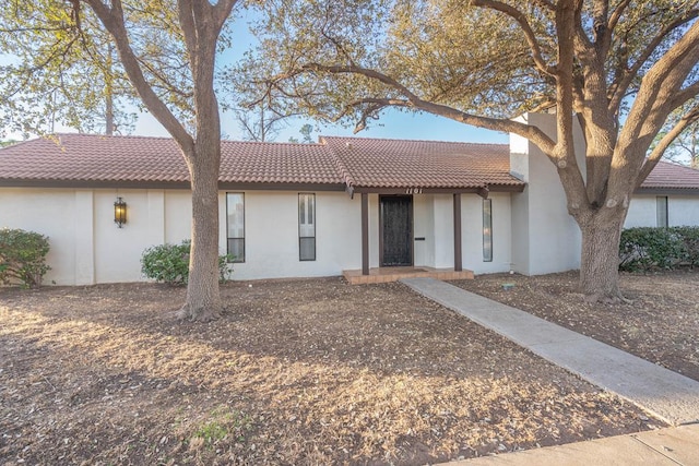 view of front facade featuring stucco siding and a tiled roof