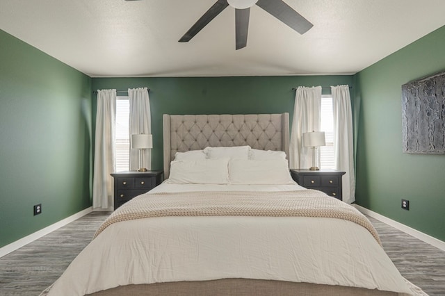 bedroom with ceiling fan and hardwood / wood-style floors