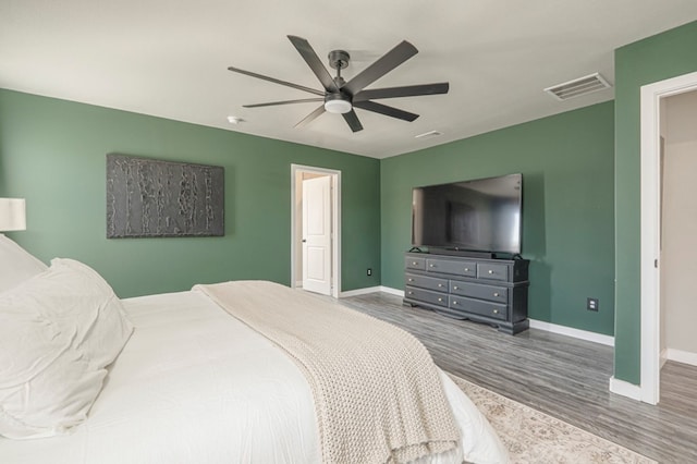 bedroom with ceiling fan and wood-type flooring