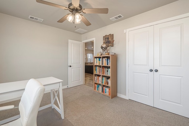 home office featuring ceiling fan and light colored carpet