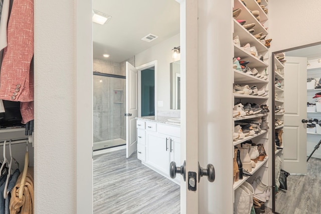 spacious closet with light hardwood / wood-style floors