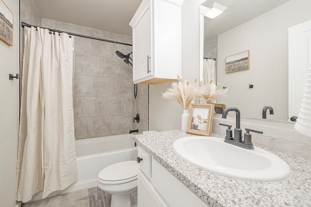 full bathroom with vanity, shower / tub combo with curtain, and toilet