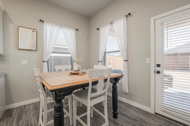 dining space with plenty of natural light and dark hardwood / wood-style floors