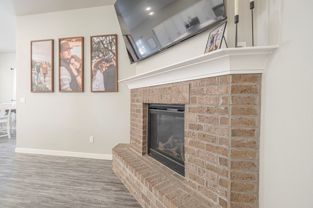 living room with hardwood / wood-style flooring and a fireplace