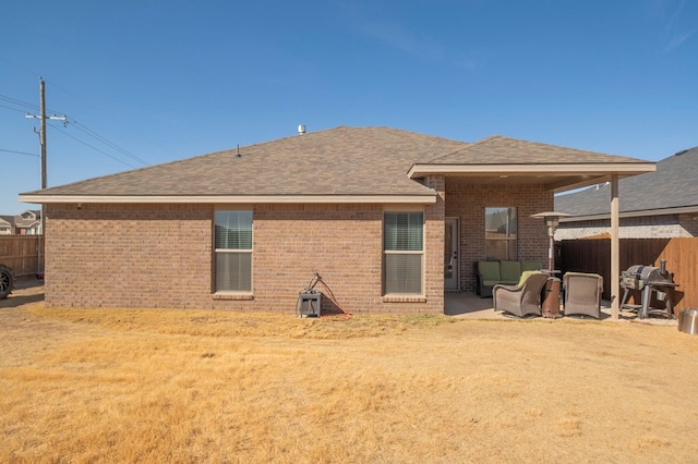 back of property with a yard and a patio area