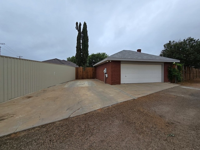 4908 Timber Ct, Midland, TX 79707 - view of property exterior with fence, brick siding, and a detached garage