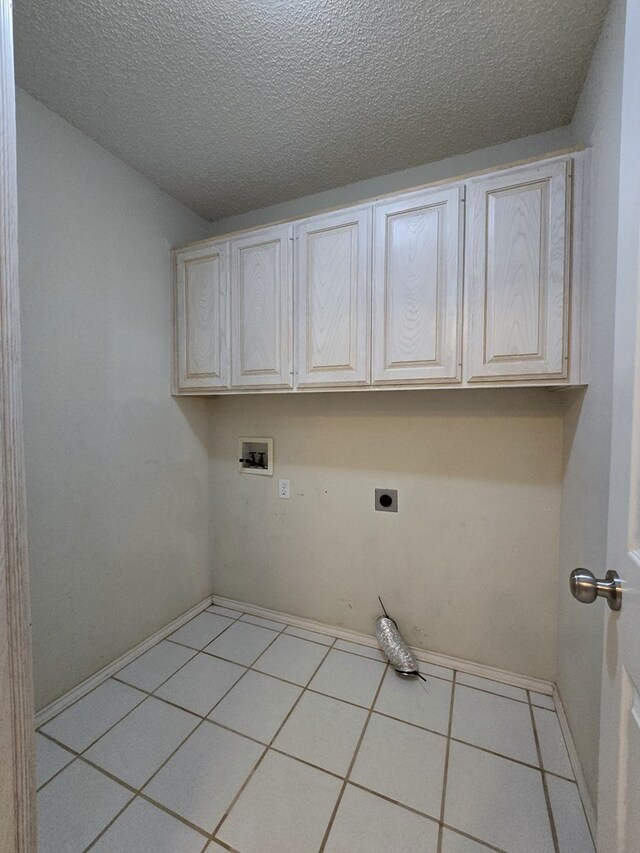 4908 Timber Ct, Midland, TX 79707 - laundry room with electric dryer hookup, cabinet space, hookup for a washing machine, a textured ceiling, and tile patterned flooring