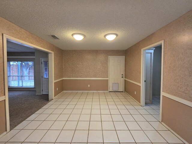 4908 Timber Ct, Midland, TX 79707 - empty room featuring a textured ceiling and light tile patterned floors