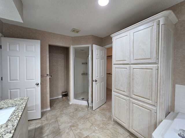 4908 Timber Ct, Midland, TX 79707 - full bathroom with a shower stall, vanity, a garden tub, and a spacious closet