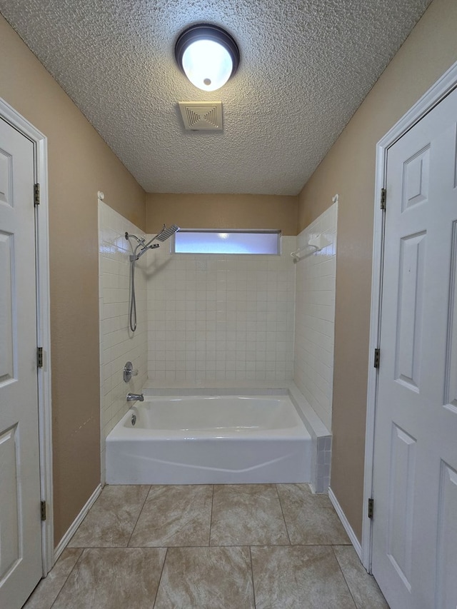 4908 Timber Ct, Midland, TX 79707 - bathroom featuring bathing tub / shower combination, tile patterned floors, a textured ceiling, and baseboards