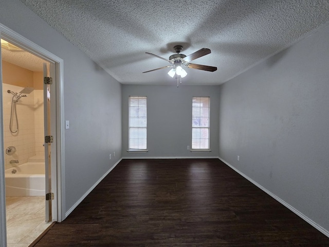 4908 Timber Ct, Midland, TX 79707 - spare room with ceiling fan, wood finished floors, a textured ceiling, and baseboards