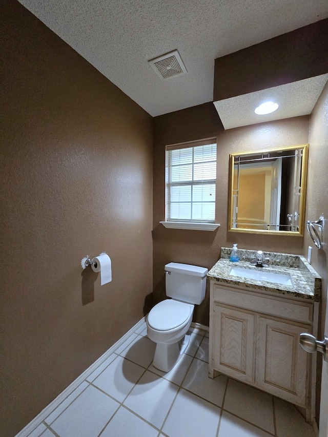 4908 Timber Ct, Midland, TX 79707 - half bathroom with toilet, tile patterned flooring, baseboards, vanity, and a textured ceiling