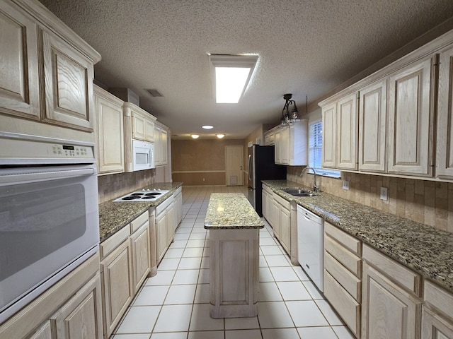 4908 Timber Ct, Midland, TX 79707 - kitchen featuring a sink, white appliances, a center island, light tile patterned floors, and tasteful backsplash