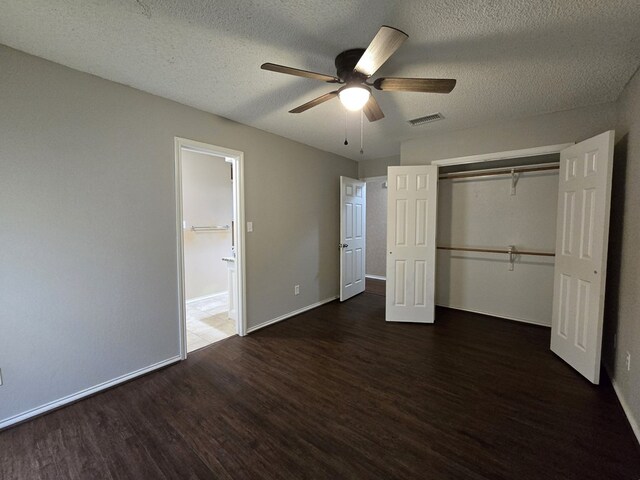 4908 Timber Ct, Midland, TX 79707 - unfurnished bedroom featuring wood finished floors, a textured ceiling, a closet, and baseboards