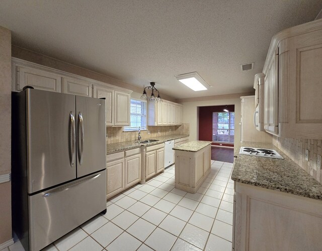 4908 Timber Ct, Midland, TX 79707 - kitchen featuring white appliances, a sink, backsplash, light tile patterned floors, and a textured ceiling