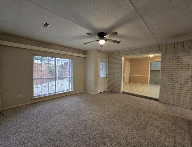 4908 Timber Ct, Midland, TX 79707 - unfurnished room featuring ceiling fan, carpet floors, baseboards, and brick wall