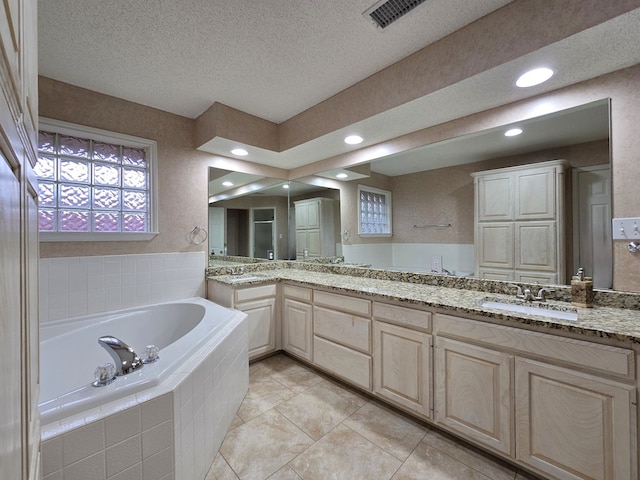 4908 Timber Ct, Midland, TX 79707 - full bath with a bath, tile patterned flooring, vanity, a textured ceiling, and recessed lighting