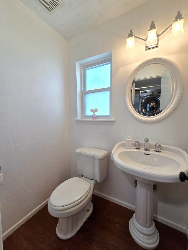 2901 Rebel Dr, Midland, TX 79707 - bathroom with toilet, wood finished floors, and baseboards