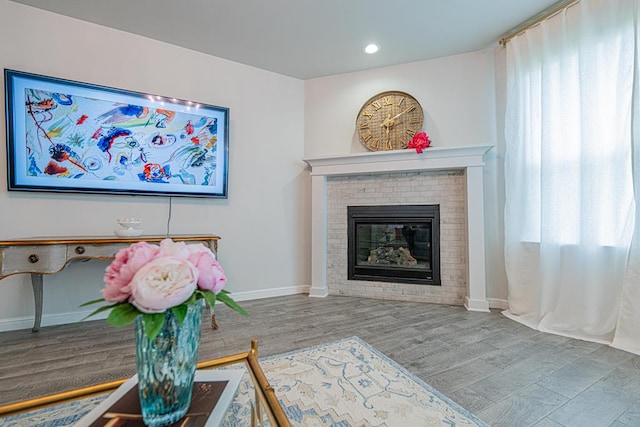 7009 Mcpherson Ln, Midland, TX 79706 - living area with a fireplace, baseboards, recessed lighting, wood finished floors, and plenty of natural light