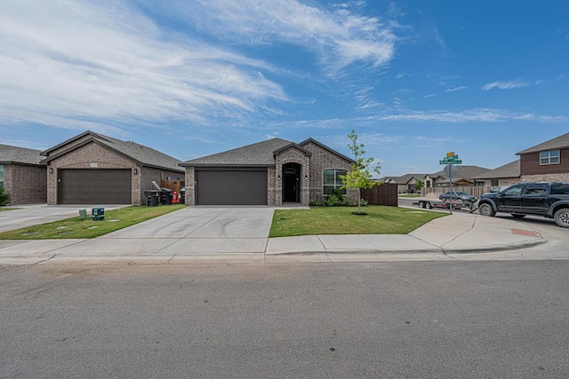 7009 Mcpherson Ln, Midland, TX 79706 - view of front of home featuring brick siding, a front yard, an attached garage, and concrete driveway