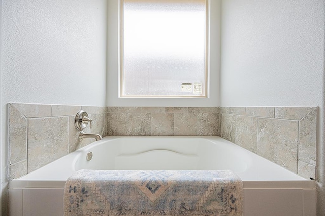7009 Mcpherson Ln, Midland, TX 79706 - full bathroom featuring a bath and a textured wall