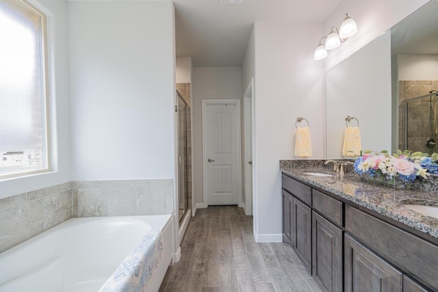 7009 Mcpherson Ln, Midland, TX 79706 - full bath with a stall shower, a garden tub, double vanity, and wood finished floors
