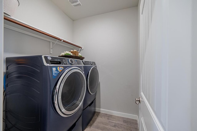 7009 Mcpherson Ln, Midland, TX 79706 - washroom with washing machine and dryer, wood finished floors, and baseboards
