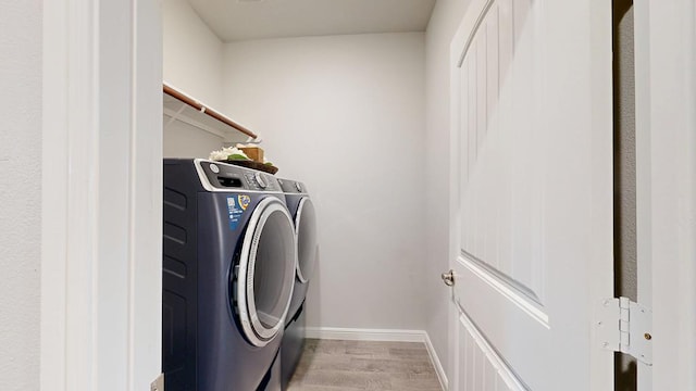 7009 Mcpherson Ln, Midland, TX 79706 - washroom featuring washing machine and dryer, light wood-style flooring, and baseboards