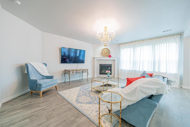 7009 Mcpherson Ln, Midland, TX 79706 - living room with a chandelier, wood finished floors, and a brick fireplace