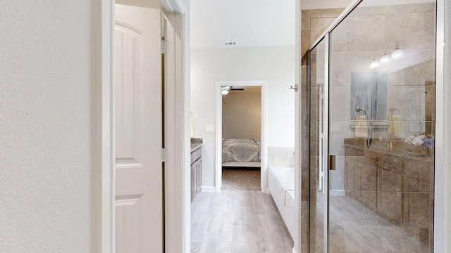 7009 Mcpherson Ln, Midland, TX 79706 - bathroom featuring connected bathroom, a stall shower, wood finished floors, and ceiling fan