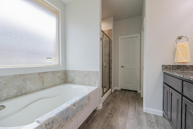 7009 Mcpherson Ln, Midland, TX 79706 - bathroom with a bath, a stall shower, and healthy amount of natural light