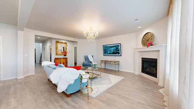 7009 Mcpherson Ln, Midland, TX 79706 - living room featuring wood finished floors, a chandelier, a glass covered fireplace, baseboards, and recessed lighting