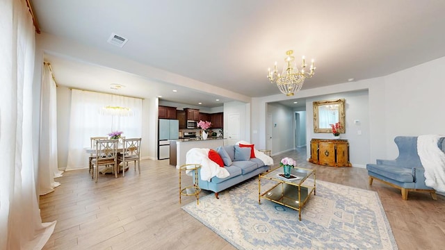 7009 Mcpherson Ln, Midland, TX 79706 - living room with a chandelier, light wood finished floors, baseboards, and recessed lighting