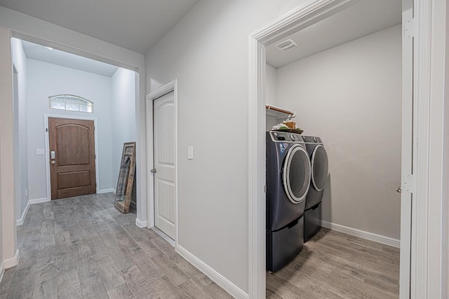 7009 Mcpherson Ln, Midland, TX 79706 - laundry area with independent washer and dryer, light wood finished floors, and baseboards