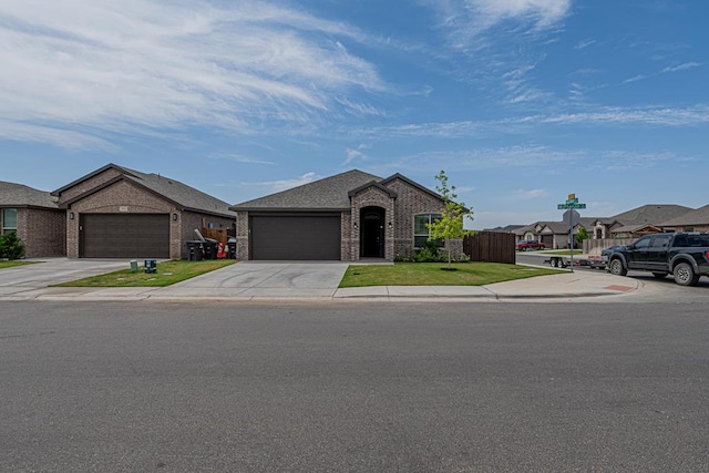 7009 Mcpherson Ln, Midland, TX 79706 - view of front facade with brick siding, an attached garage, concrete driveway, and a residential view