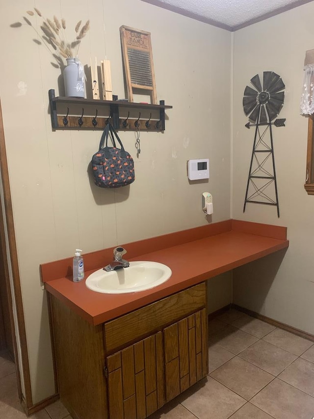 bathroom with vanity, a textured ceiling, and tile patterned floors