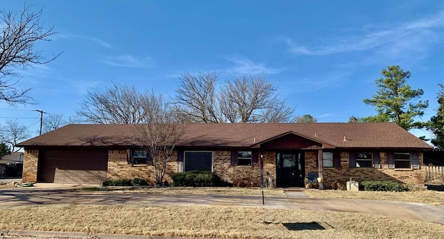 ranch-style home with an attached garage, concrete driveway, and brick siding