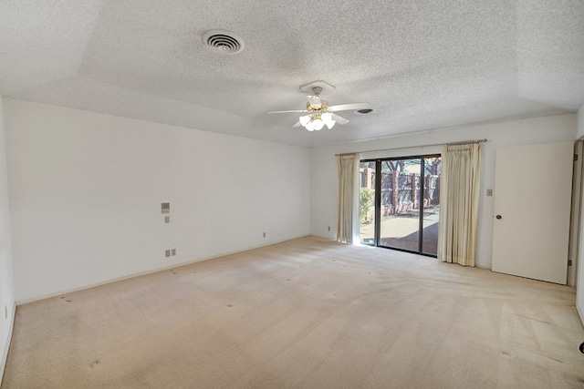 carpeted spare room with ceiling fan and a textured ceiling