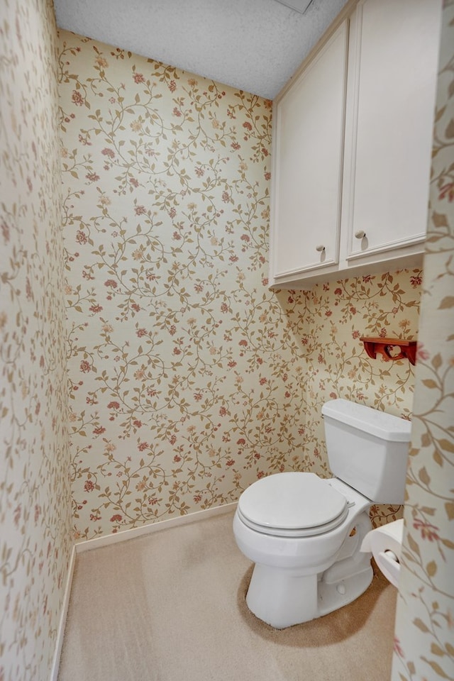 bathroom featuring a textured ceiling and toilet