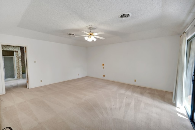 carpeted empty room with a textured ceiling and ceiling fan