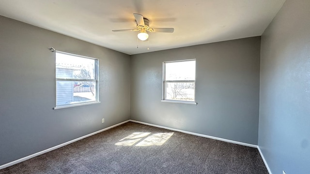 unfurnished room with ceiling fan and carpet