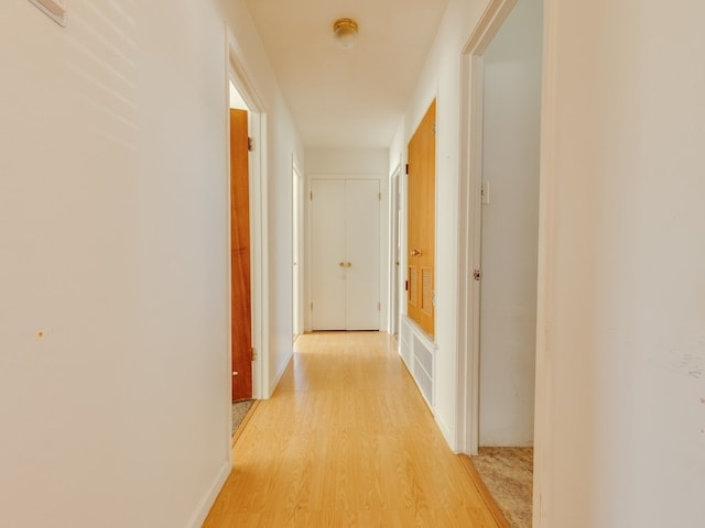 corridor featuring light hardwood / wood-style floors