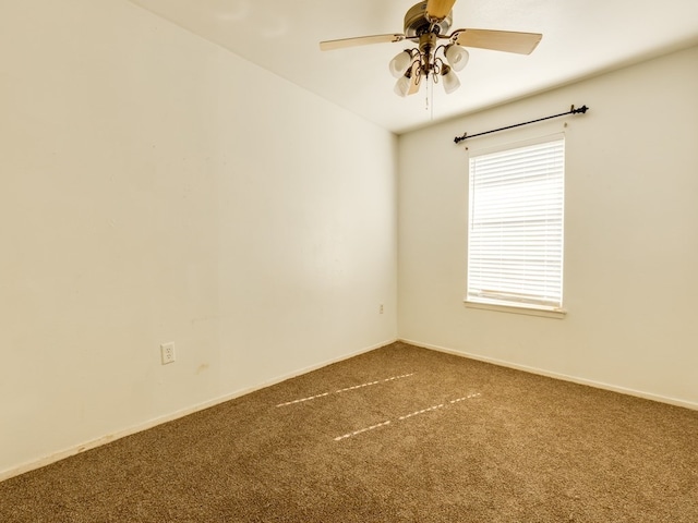 empty room with ceiling fan and carpet flooring