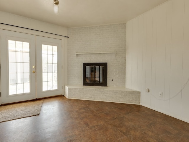 unfurnished living room with a fireplace and french doors