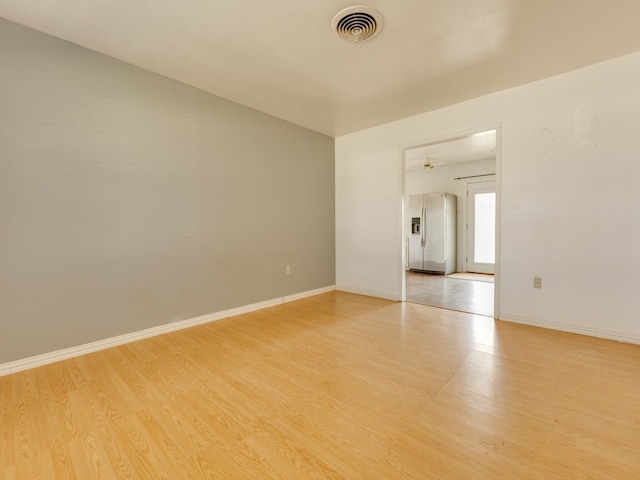 empty room with light hardwood / wood-style flooring