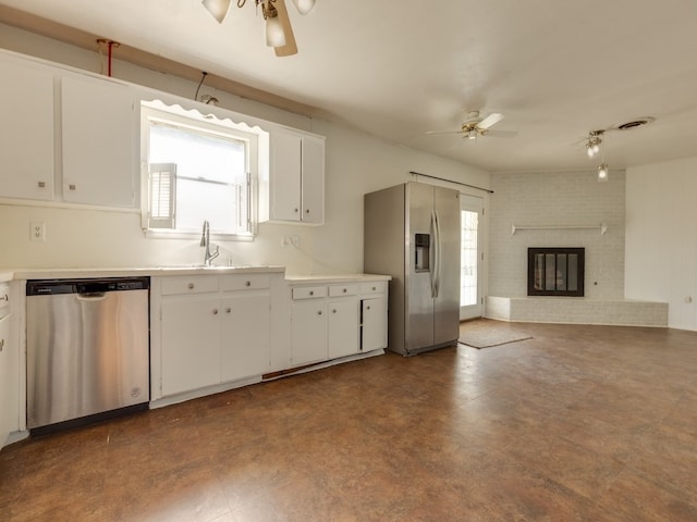 kitchen with ceiling fan, appliances with stainless steel finishes, and white cabinets