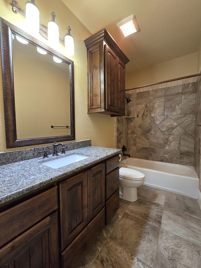 full bathroom featuring vanity, toilet, and tiled shower / bath combo