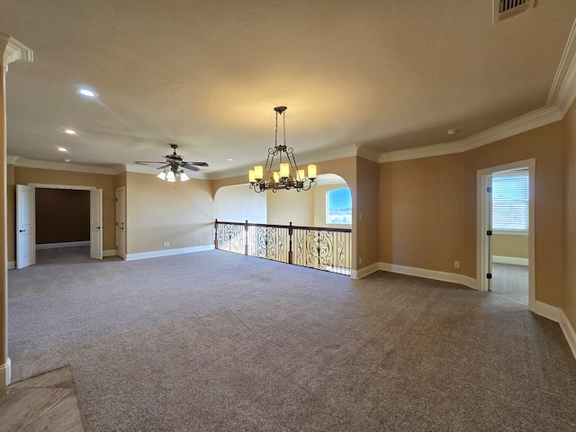 unfurnished living room with carpet flooring, ceiling fan with notable chandelier, and ornamental molding