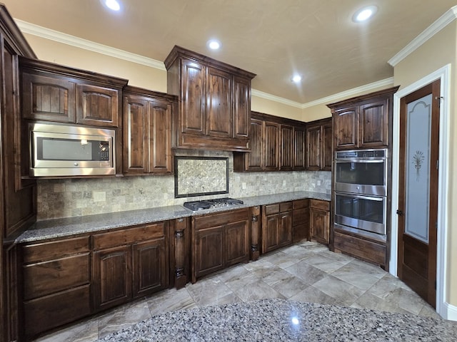 kitchen with dark brown cabinets, stainless steel appliances, tasteful backsplash, and ornamental molding