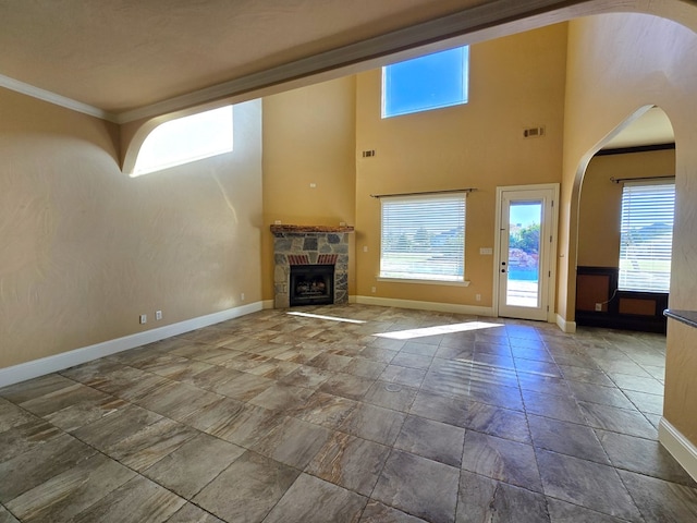 unfurnished living room with a fireplace and ornamental molding